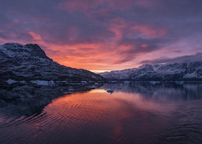 Hand holding black machined steel mechanical pencil with brass tip and top.