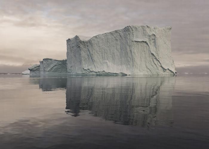 Hand holding black machined steel mechanical pencil with brass tip and top.