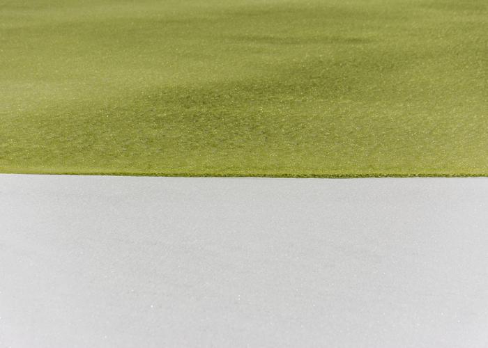 Hand holding black machined steel mechanical pencil with brass tip and top.