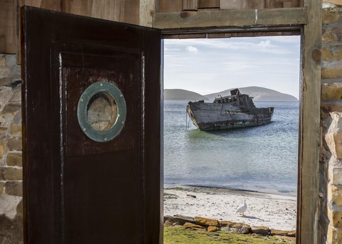 Hand holding black machined steel mechanical pencil with brass tip and top.